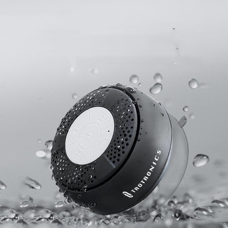 Raetronics shower speaker with water droplets on a gray background