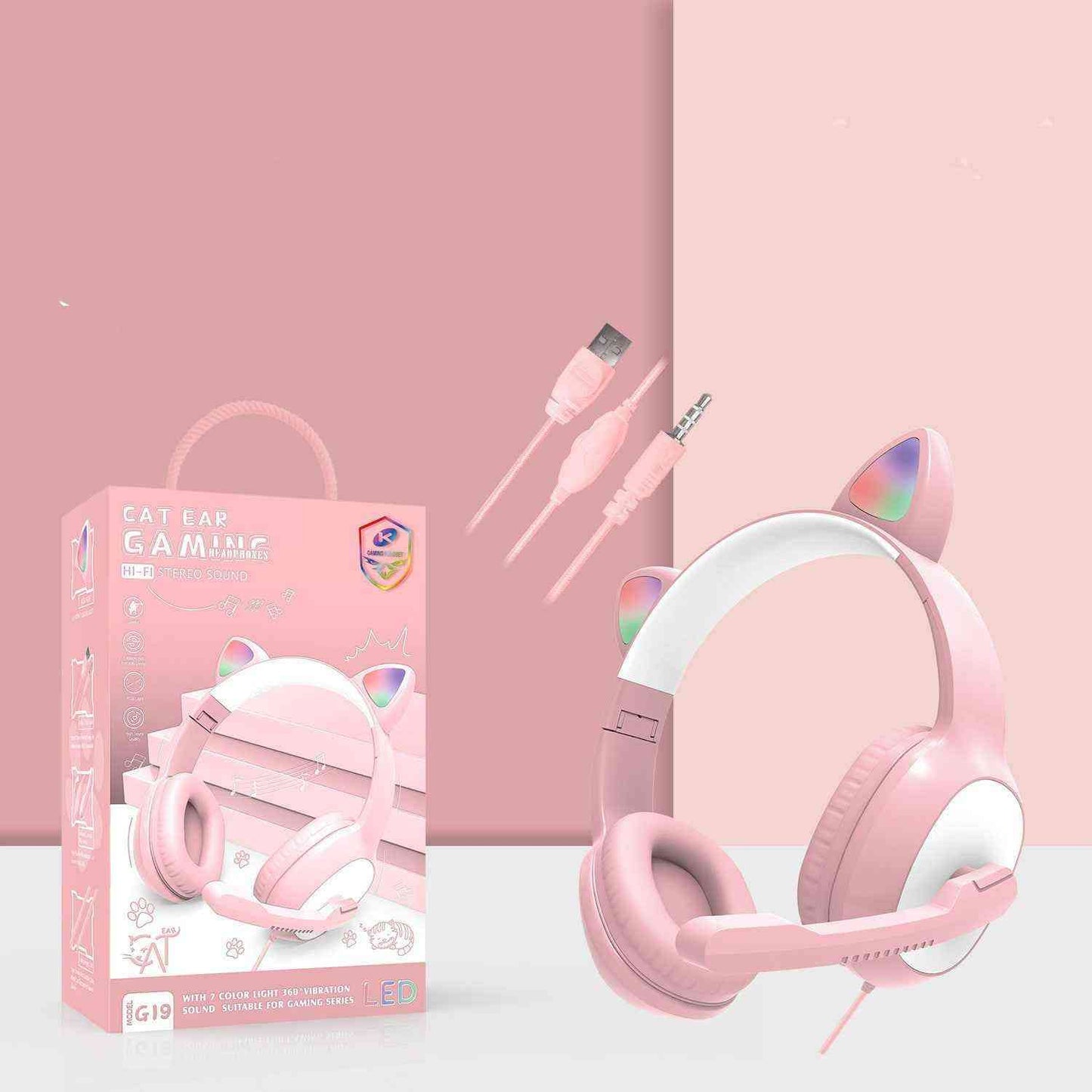 Pink cat ear gaming headset with packaging, cable, and microphone on a pink background