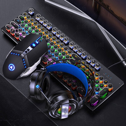 Gaming keyboard, mouse, and headphones on a dark surface with a blurred background