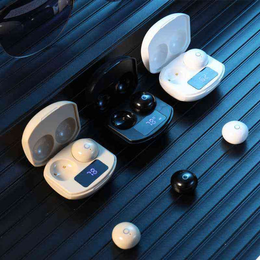 Wireless earbuds with charging cases on a dark surface