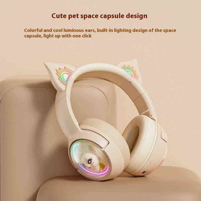 Headphones with space capsule design and colorful lighting on a beige background