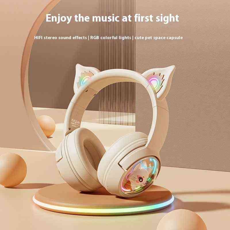 White headphones with cat ear design on a stand, featuring RGB lights, on a neutral background.
