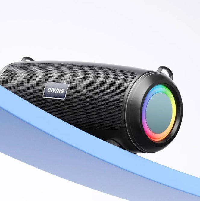 Black cylindrical speaker with colorful LED ring on a white background
