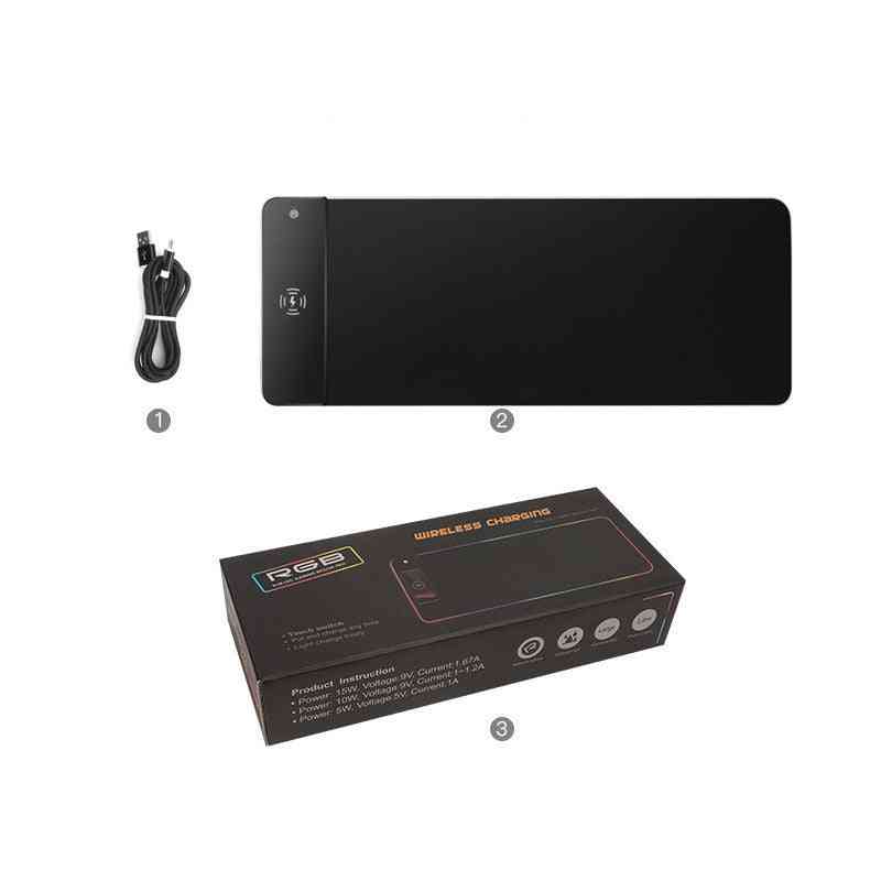 Black wireless charging pad with cable and packaging on a white background