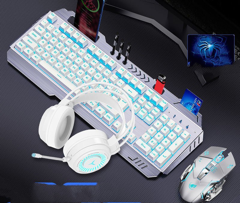 Gaming keyboard, mouse, and headset on a dark surface with a computer monitor in the background.