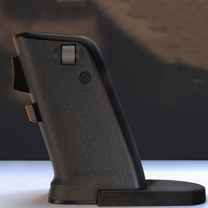 Black gun grip on a reflective surface with a dark background
