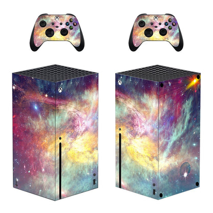 Gaming console and controllers with galaxy-themed skin on a white background