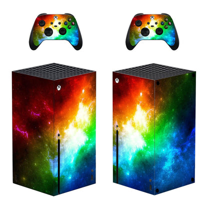 Gaming console and controllers with a colorful nebula design on a white background